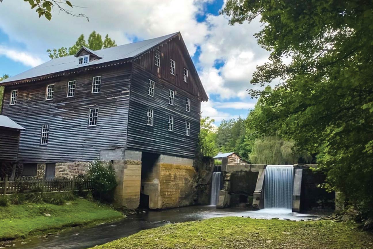A historic mill as viewed from the stream below