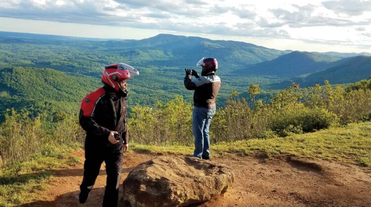 Two riders pause to take in the view at an overlook