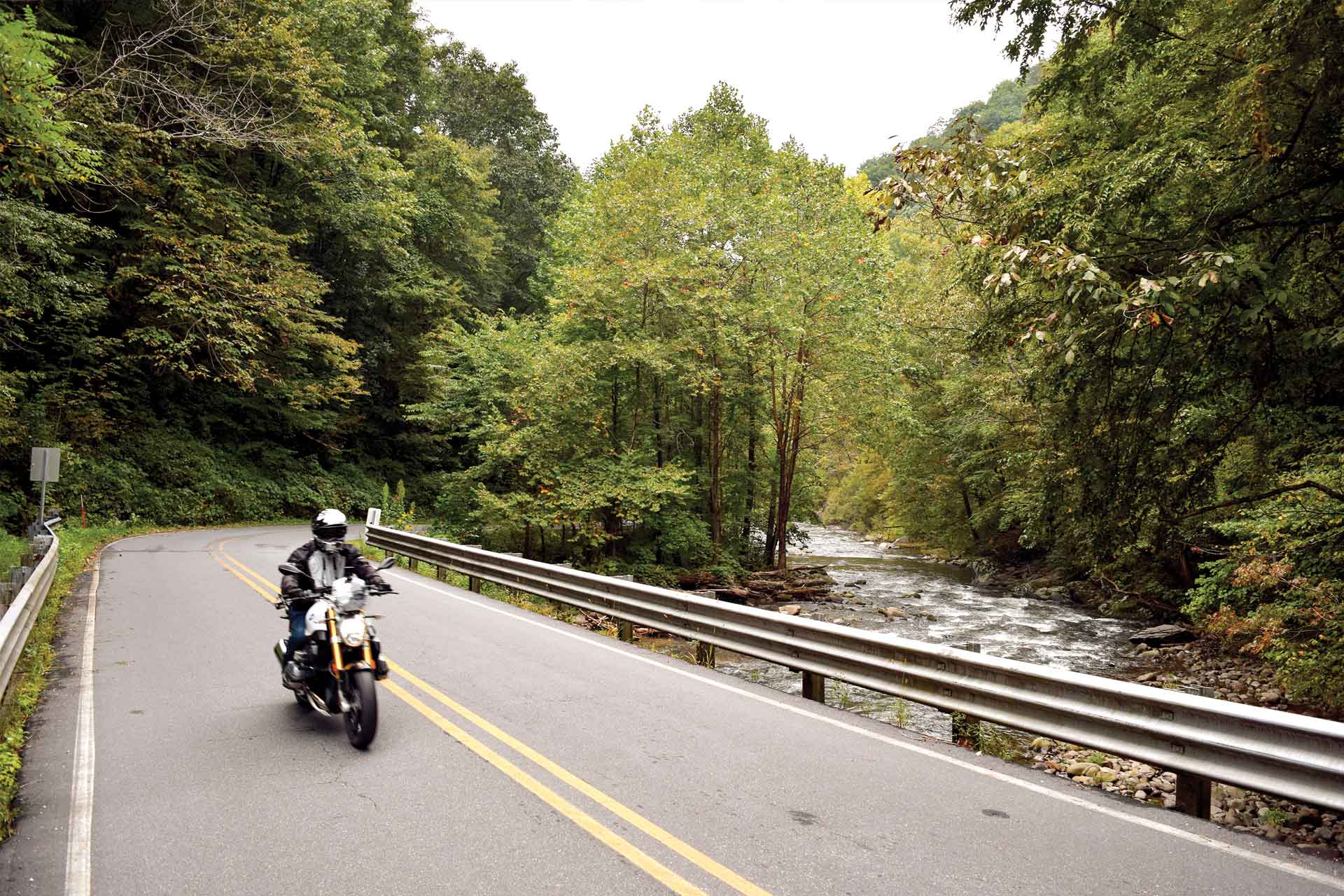 A rider takes the backroad alongside a creek.