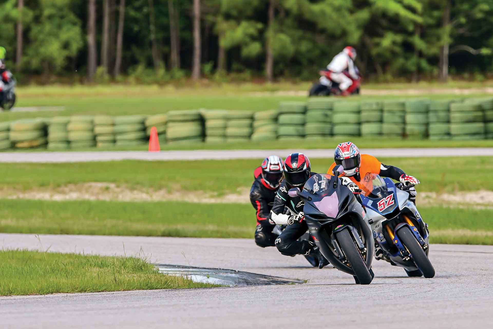 Riders do laps at a track day event
