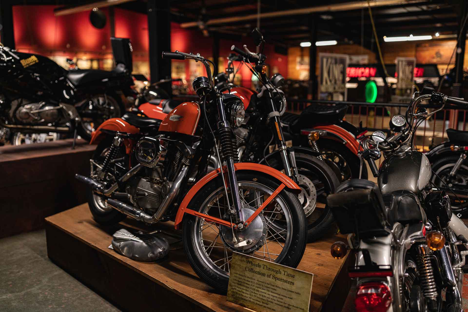 A collection of Harley-Davidson Sportsters inside Wheels Through Time Museum.