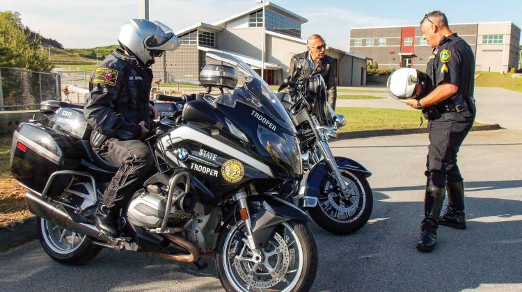 A North Carolina State Trooper gives instruction to two motorcycle riders