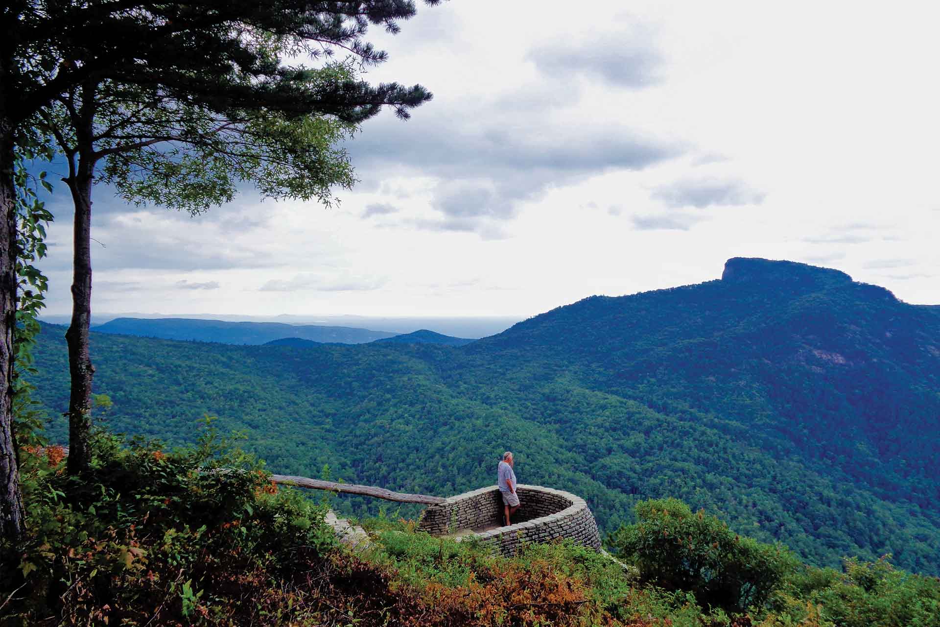 A panoramic shot of a man at an overlook observing Wiseman's View