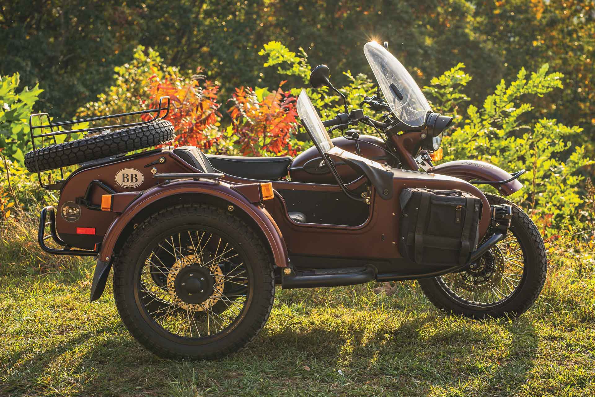 A burgundy motorcycle with a sidecar